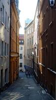 walking in the historic center of Stockholm. You can see the construction site cranes and a hot air balloon. photo