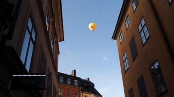 walking in the historic center of Stockholm. You can see the construction site cranes and a hot air balloon. photo