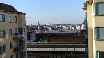 walking in the historic center of Stockholm. You can see the construction site cranes and a hot air balloon. photo