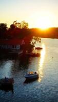 Digital painting style representing boats docked near a house at sunset photo