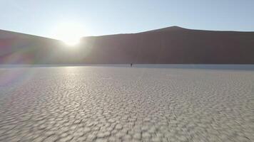 A girl walks along the dried up bottom of a river in the valley of Dedvlei video