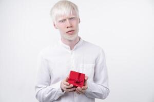 portrait of an albino man in  studio dressed t-shirt isolated on a white background. abnormal deviations. unusual appearance photo