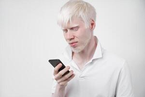albinism albino man in studio dressed t-shirt isolated on a white background. abnormal deviations. unusual appearance photo