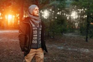 portrait of a bearded hipster tourist man in the woods forest photo