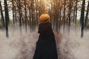 Portrait of a scary Jack-lantern with a pumpkin on his head. Halloween legend. photo