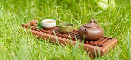 Chinese tea ceremony Asian wooden table board chaban top view copy space morning energy. photo