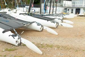 Morgat, France 29 May 2018 Catamarans storage without sails parked on the beach photo