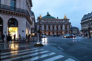 Paris, France 01 June 2018 Traffic cars in front of Opera, Paris. The Palais Garnier is a 1,979-seat opera house, which was built from 1861 to 1875 for the Paris Opera photo