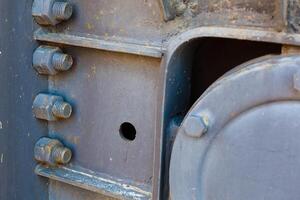 Big rusty metal nuts locked with rust and corrosion bolts photo