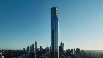 ai generado moderno rascacielos torre se eleva en medio de urbano paisaje enmarcado por claro azul cielo foto