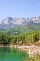 Scenic view of Doyran Pond with reflection of mountains. Antalya, Turkey. photo