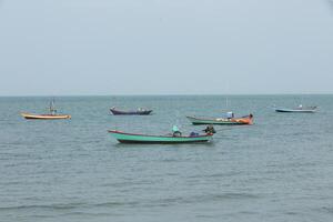 Row of fishing boat floating on the sea. photo