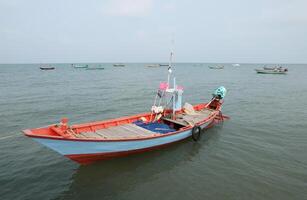 Colorful fishing boat floating on the sea. photo