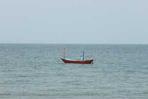 Colorful fishing boat floating on the sea. photo