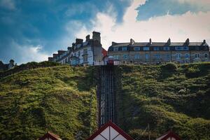 Quaint hillside buildings overlooking a funicular railway on a sunny day with blue skies and fluffy clouds in Saltburn-by-the-Sea, England. photo