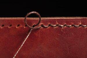 A stitching with threads on a leather product. photo