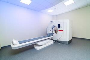 Newest CT, MRI scanner in a modern hospital. Up-to-date equipment for diagnosting diseases. Clinic room with no people. Closeup. photo