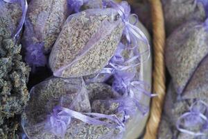 A stack of purple lavender bags fills the basket, creating a beautiful pattern photo