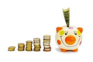 Piggybank and money tower , to save , saving money for affordable things, financial concept .Piggybank or deposit box on a white background, depict saving money to make a trust fund for children photo