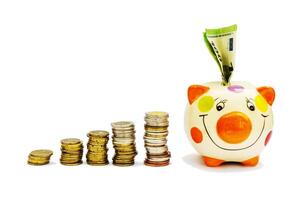 Piggybank and money tower , to save , saving money for affordable things, financial concept .Piggybank or deposit box on a white background, depict saving money to make a trust fund for children photo
