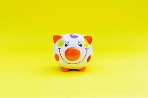 Piggybank on a yellow background. to save , saving money for affordable things, financial concept .Piggybank or deposit box on a wood background, depict saving money to make a trust fund for children photo