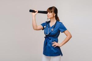 Female Brunette Doctor Looking at Tomography X-ray Film photo