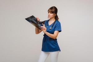 Female Brunette Doctor Looking at Tomography X-ray Film photo