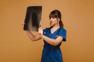 Female Brunette Doctor Looking at Tomography X-ray Film photo