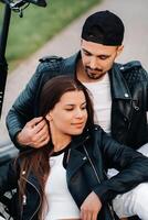 portrait of a couple sitting near electric scooters, enjoying time in nature together, Two lovers on electric scooters.People on scooters photo