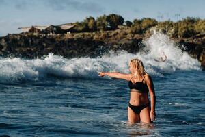 A girl with wet hair happily swims on the waves in the Atlantic Ocean.Tenerife.Spain photo