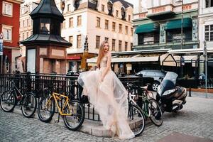 A bride in a wedding dress with long hair in the old town of Wroclaw. Wedding photo shoot in the center of an ancient city in Poland.Wroclaw, Poland