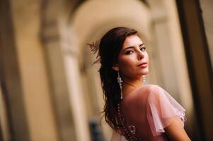 A young beautiful bride stands at the center of the Old city of Florence in Italy. Bride in a beautiful pink dress in Tuscany.Italy photo