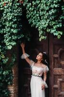 A bride in a white dress in the old town of San Gimignano.A girl walks around the city in Italy.Tuscany. photo