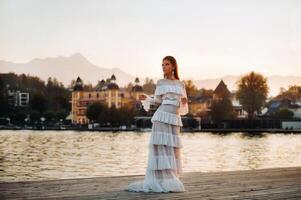 Bride in white wedding dress in the old town of Velden am w rthersee.Model in a wedding dress in Austria.Alps photo