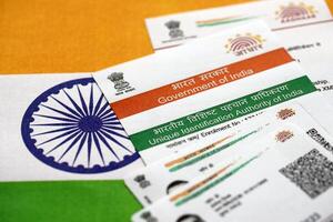 Indian Aadhaar card from Unique Identification Authority of India on Indian flag photo