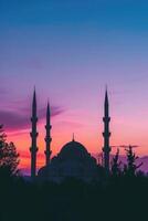 AI generated Majestic Sunset Behind Mosque Minarets in Tranquil Evening. photo