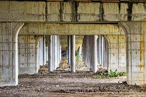 under toll road bridges or highways where there are many bridge pillars. perspective view. photo