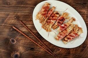 Enoki mushroom roll appetizer fried in bacon photo