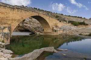 2nd century AD Severan roman bridge on the Cendere River with the columns of the Roman Emperor Septimus Severus and the Empress Julia Domna, Turkey photo