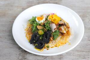 Country Style Pancit Palabok pasta noodles served in a dish isolated on grey background side view photo