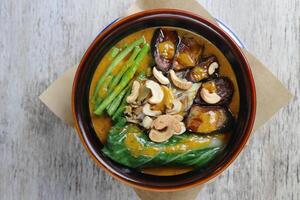 Beef Kare Kare sa Buntot with nuts served in a dish isolated on grey background side view photo