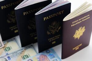 3 United States and 1 France passport on visable currency transparent background photo