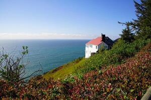 White house on cliffs of Cape Foulweather photo