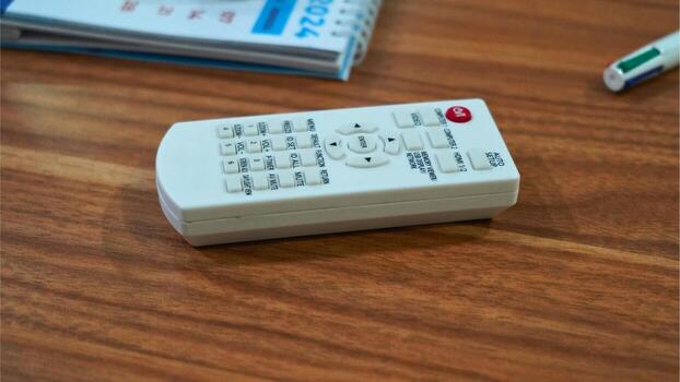 The remote control has various buttons labeled with functions such as MENU, SET, MUTE,and VOL. photo
