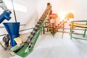 Conveyors at plant. Moving vertical belt with moving empty boxes. Factory equipment. photo