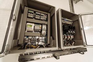 Electrical panel at a assembly line factory. Controls and switches.. Color wires in a box of distribution of an electricity. photo