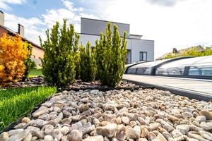 Beautiful modern house. Concrete out-to-date building. View from the garden. photo