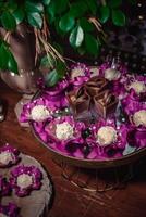 Chocolate cups and white brigadeiro. Table decorated with party sweets, luxury food photo