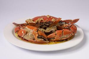 BUTTER GINGER CRAB WOKKIN in a dish top view on grey background singapore food photo