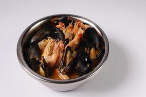 PIER SPECIAL CLAWPINNO prawn, shellfish and crab soup in bowl top view on grey background singapore food photo